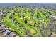 Scenic aerial view of a lush golf course with ponds and mature trees at 3559 Towne Dr, Carmel, IN 46032