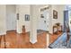 Hallway with wood floors featuring white trim and neutral paint at 3559 Towne Dr, Carmel, IN 46032
