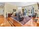 Comfortable living area with hardwood floors, large windows, and traditional furnishings at 3559 Towne Dr, Carmel, IN 46032