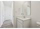 Well-lit half bathroom with white vanity, framed mirror, and neutral paint at 379 Antioch St, Greenfield, IN 46140