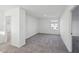 Spacious bedroom with neutral carpet, white walls, and a view of the backyard at 379 Antioch St, Greenfield, IN 46140