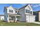 Charming two-story home with gray siding, brick accents, and a well-manicured lawn at 379 Antioch St, Greenfield, IN 46140