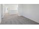 Neutral hallway with white walls, grey carpet, white doors, and natural light at 379 Antioch St, Greenfield, IN 46140