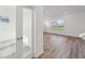 Bright living room with hard wood floors, white walls, and view of neighborhood through the window at 379 Antioch St, Greenfield, IN 46140