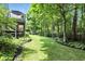 Expansive backyard featuring a lush lawn and mature trees, creating a private and serene outdoor space at 380 Raintree Dr, Zionsville, IN 46077