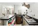 Finished basement bar area featuring dark countertop, cabinets and shelving, decorative elements and a deer head mount at 380 Raintree Dr, Zionsville, IN 46077