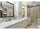 Stylish bathroom with double vanity, granite countertop, and glass-enclosed shower at 380 Raintree Dr, Zionsville, IN 46077