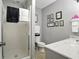 Clean bathroom featuring white marble vanity, tiled floors, frosted shower and coordinated decor at 380 Raintree Dr, Zionsville, IN 46077