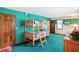 Fun bedroom with wooden bunk beds, blue-green walls, and wood trim accents at 380 Raintree Dr, Zionsville, IN 46077