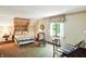 Relaxing bedroom with a canopy bed, sitting area, and lots of natural light from the window at 380 Raintree Dr, Zionsville, IN 46077