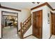 Inviting foyer with hardwood floors, staircase, and wood trim with an open view to the living room at 380 Raintree Dr, Zionsville, IN 46077
