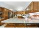 Well-lit kitchen featuring oak cabinets, granite countertops, and stainless steel appliances at 380 Raintree Dr, Zionsville, IN 46077