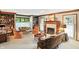 Cozy living room with fireplace, built-in shelving, and an abundance of natural light at 380 Raintree Dr, Zionsville, IN 46077