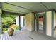 Inviting porch features stone columns, a neutral door, and peaceful views of mature trees and manicured landscaping at 380 Raintree Dr, Zionsville, IN 46077