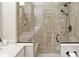 Updated shower featuring elegant tile work, glass enclosure, and modern fixtures at 380 Raintree Dr, Zionsville, IN 46077