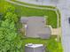 Aerial view of the house showing the roof, deck, lawn, and surrounding greenery at 3843 Grove Tree Ln, Indianapolis, IN 46203