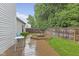 Backyard with a wooden deck, green lawn, and privacy fence at 3843 Grove Tree Ln, Indianapolis, IN 46203