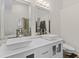 Bathroom features a dual vanity with vessel sinks, modern fixtures, and a large, frameless mirror at 3843 Grove Tree Ln, Indianapolis, IN 46203