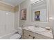 Bathroom includes a tub/shower combo, updated vanity, marble countertop, and a framed mirror at 3843 Grove Tree Ln, Indianapolis, IN 46203