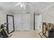 Bright bedroom features three doors, a full-length mirror, and light wood-look flooring at 3843 Grove Tree Ln, Indianapolis, IN 46203