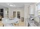 Eat-in kitchen showcases a granite sink, stainless steel appliances, breakfast table, and exterior access at 3843 Grove Tree Ln, Indianapolis, IN 46203