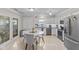 Bright kitchen featuring white cabinets, stainless steel appliances, and a cozy breakfast area at 3843 Grove Tree Ln, Indianapolis, IN 46203