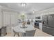 Well-lit kitchen showcasing white cabinetry, granite countertops, and stainless steel appliances at 3843 Grove Tree Ln, Indianapolis, IN 46203
