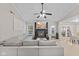 Bright living room with views into the kitchen and a cozy grey sectional with a fireplace at 3843 Grove Tree Ln, Indianapolis, IN 46203