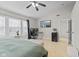 This primary suite features a TV, a ceiling fan, natural light, and a dedicated work space at 3843 Grove Tree Ln, Indianapolis, IN 46203