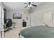 Spacious bedroom featuring a ceiling fan, vaulted ceiling, desk, and mounted television at 3843 Grove Tree Ln, Indianapolis, IN 46203
