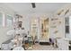 Bright sun room featuring custom cat structures, white wood paneling, and access to the kitchen at 3843 Grove Tree Ln, Indianapolis, IN 46203