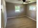 This bedroom features hard wood floors, a ceiling fan, and bright windows at 3906 N Lanewood Dr, Muncie, IN 47304