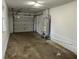 Spacious garage with concrete floors and a water heater at 3906 N Lanewood Dr, Muncie, IN 47304