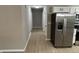 Hallway with hardwood floors and doors to nearby rooms and the kitchen at 3906 N Lanewood Dr, Muncie, IN 47304