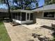 Enclosed sun room with a connecting paver patio and an exterior constructed of stone at 3906 N Lanewood Dr, Muncie, IN 47304