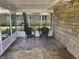 Relaxing sunroom with two wicker chairs and a neutral rug, perfect for enjoying the outdoors in comfort at 3906 N Lanewood Dr, Muncie, IN 47304