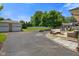 Open backyard with a patio area with comfortable seating, fire pit, shed, and a detached garage at 45 Kirk E Dr, Indianapolis, IN 46234