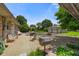 Backyard featuring patio, chairs, grill, yard, trees, blue skies, and a detached garage at 45 Kirk E Dr, Indianapolis, IN 46234