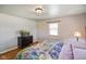 Comfortable bedroom with hardwood flooring, a dresser, a window with blinds, and a stylish ceiling light at 45 Kirk E Dr, Indianapolis, IN 46234