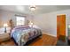 Bedroom featuring beautiful hardwood floors and a brass-colored iron bed frame, and a decorative ceiling light at 45 Kirk E Dr, Indianapolis, IN 46234