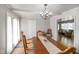 Cozy dining area with chandelier lighting adjacent to the bright living room at 45 Kirk E Dr, Indianapolis, IN 46234