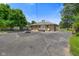A stone-clad home with a backyard patio, detached garage, and landscaping on a sunny day at 45 Kirk E Dr, Indianapolis, IN 46234