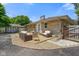 Back of home featuring a stone exterior, outdoor seating area, detached garage, and landscaping at 45 Kirk E Dr, Indianapolis, IN 46234