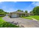 Charming single-story home featuring a stone facade, attached garage, and spacious circular driveway at 45 Kirk E Dr, Indianapolis, IN 46234