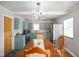 Charming dining area with mint cabinets, stainless appliances, and chandelier lighting at 45 Kirk E Dr, Indianapolis, IN 46234