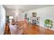 Open living room with hardwood floors, stone fireplace, and access to the kitchen area at 45 Kirk E Dr, Indianapolis, IN 46234