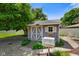 A backyard shed surrounded by lush greenery, landscaping, and decorative rocks at 45 Kirk E Dr, Indianapolis, IN 46234