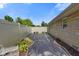 A side yard next to a stone home with landscaping and a privacy fence for added seclusion at 45 Kirk E Dr, Indianapolis, IN 46234