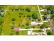 Large grassy lot with mature trees, a pond and detached garage in a neighborhood setting at 4644 E 150 N, Anderson, IN 46012