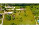 Expansive property featuring a large yard, mature trees, a pond, and multiple outbuildings with approximate boundary lines at 4644 E 150 N, Anderson, IN 46012